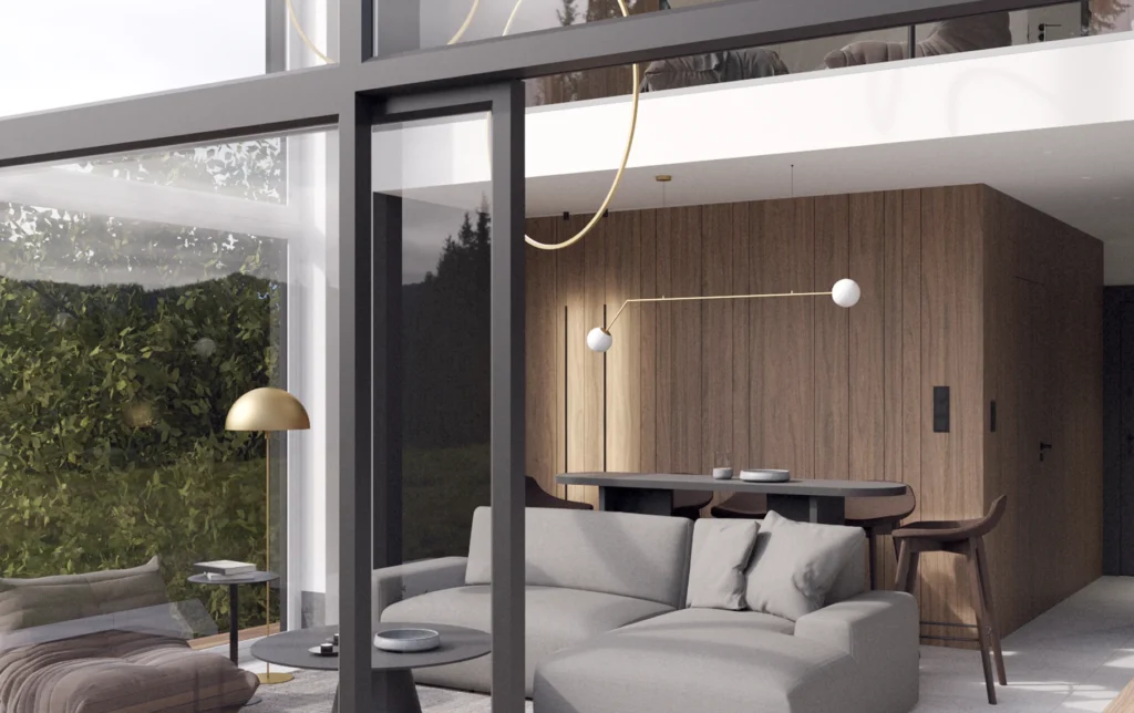 Salon willi Treesna z panoramicznym przeszkleniem, widokiem na las i designerskim oświetleniem nad stołem jadalnym.